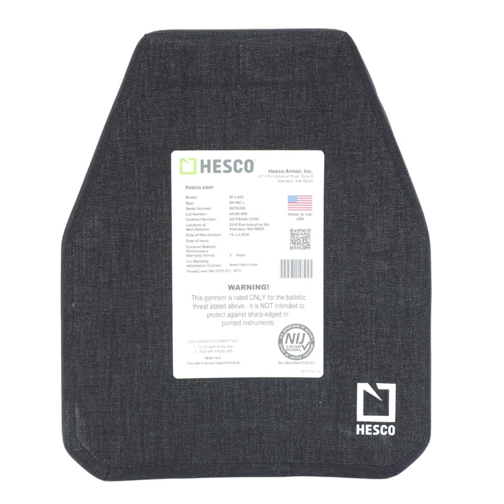 A black Hesco RF3-400 ballistic armor plate with a white label displaying specifications, manufacturer details, an American flag, and safety warnings, positioned on a plain white background. This ceramic/composite armor plate offers light AP protection while maintaining a sleek design.