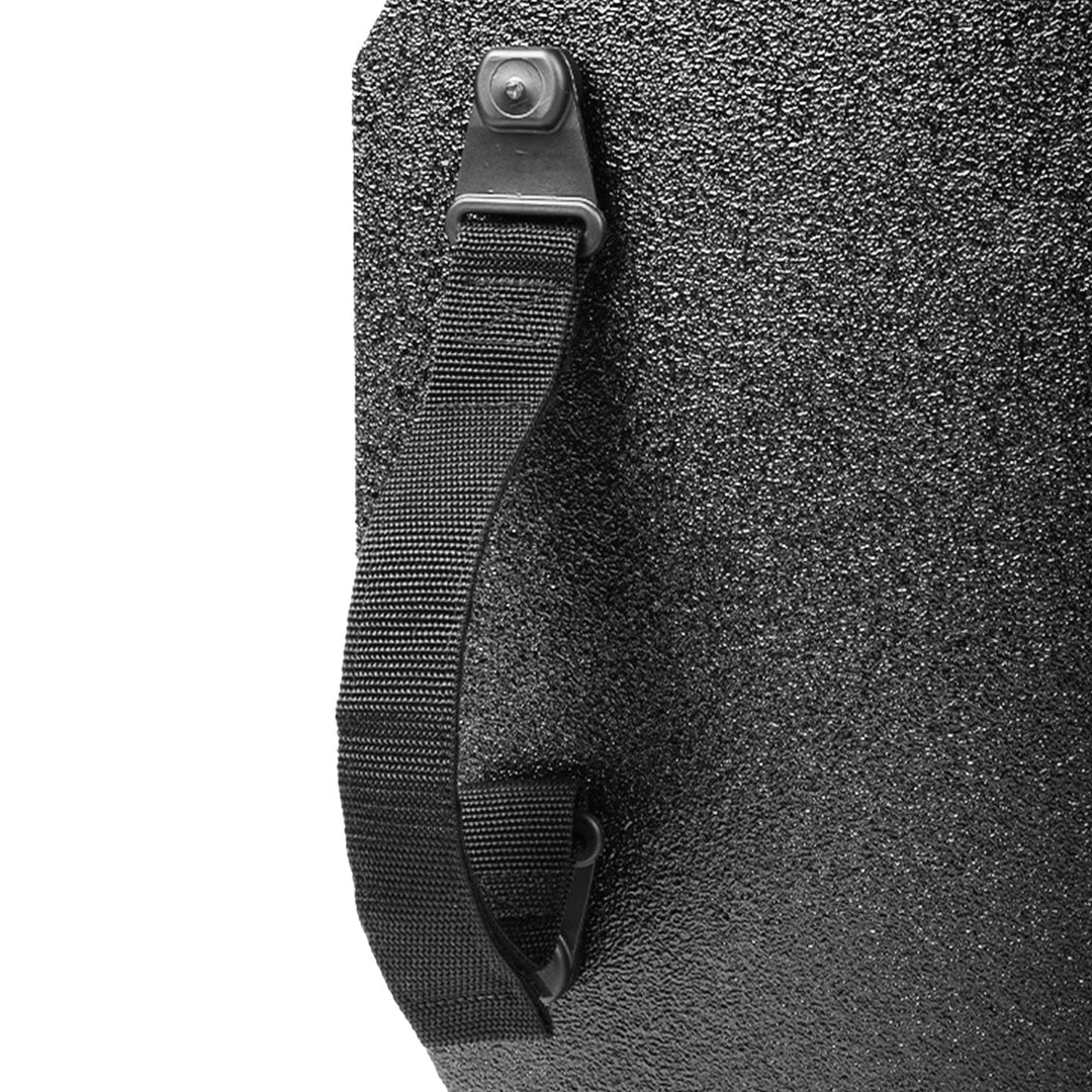 Close-up view of a black, textured surface with a black fabric strap attached to it. The strap is secured with metal rivets, showcasing the robust design characteristic of the Premier Body Armor STRATIS Pro Shield Level III+.