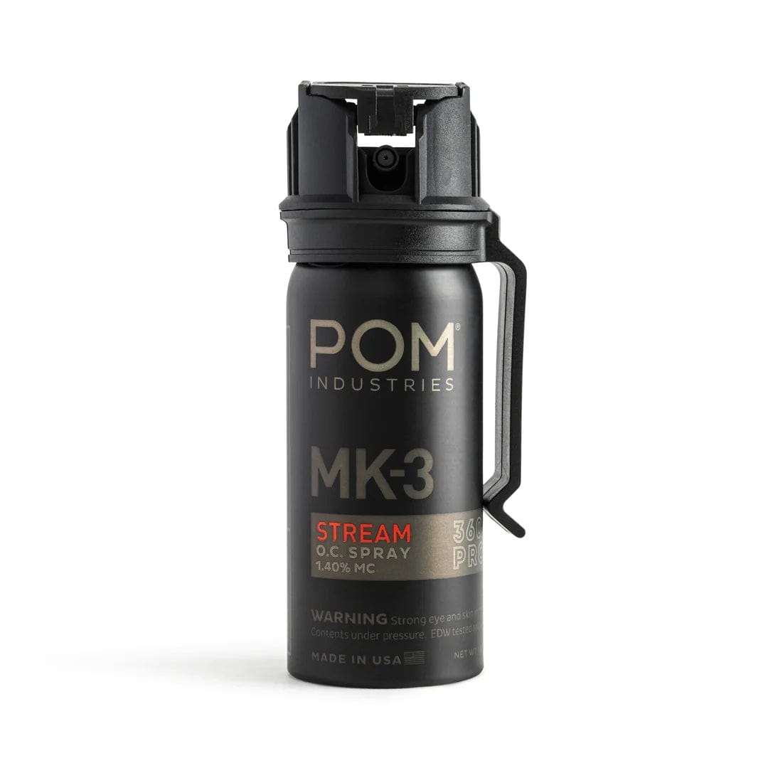 A POM MK-3 Pepper Spray canister from POM is shown upright with a safety cap and side clip against a white background, providing professional-grade self-defense.