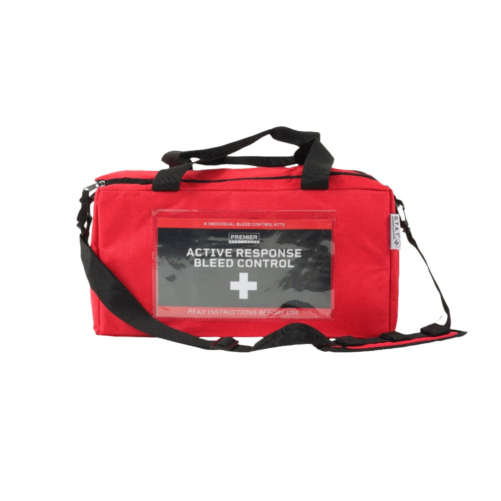 The STAT Active Response Bleed Control Kit is a red emergency bag with black handles and a detachable shoulder strap. Designed for critical situations, it features a transparent front pocket displaying a label and instructions. This comprehensive bleed control kit includes the S.T.A.T. Tourniquet for rapid response.