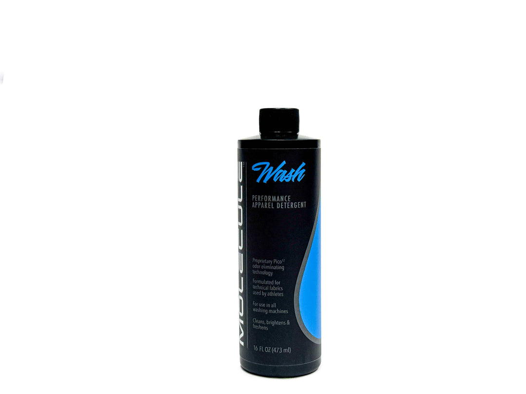 A black bottle of Molecule Vest &amp; Carrier Detergent with a blue label stands upright on a white background. Specially formulated as a duty uniform detergent, this 16 fl oz (473 mL) bottle with a black cap is designed to care for technical fabrics and enhance moisture management.