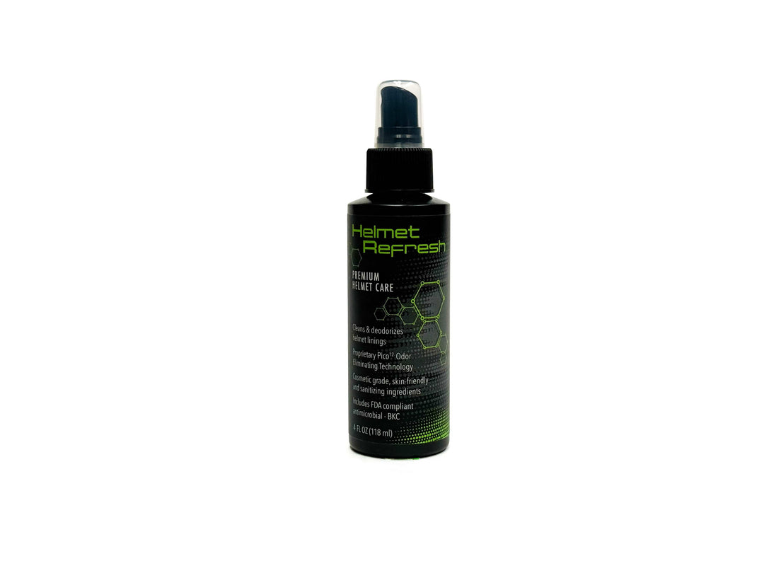 A black Molecule Helmet Refresh Spray bottle with green and white text sits on a white background. The label highlights its deodorizing and odor-removal features, making it an effective helmet deodorizer. The bottle is topped with a spray nozzle.