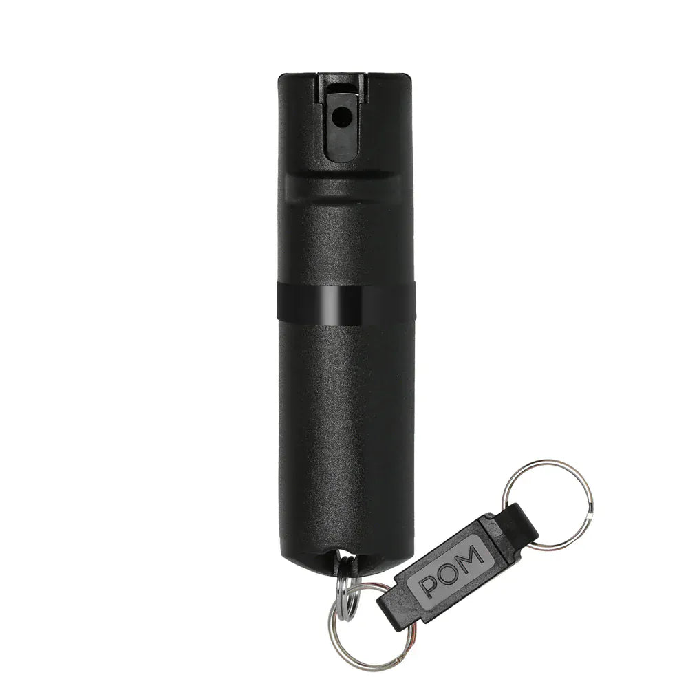 The POM Keychain Pepper Spray by POM is a small black compact canister with a keychain attachment, displayed against a plain white background.