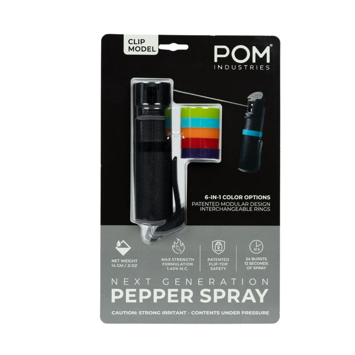 A package includes the POM Clip Pepper Spray by POM, six color rings, and packaging that lists weight, formulation, spray range, and number of bursts.