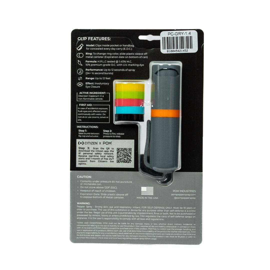 Back view of POM Clip Pepper Spray packaging by POM, featuring product details, usage instructions, caution info, barcode, and manufacturer details. This compact EDC tool has a gray case with an orange stripe and a keychain clip.
