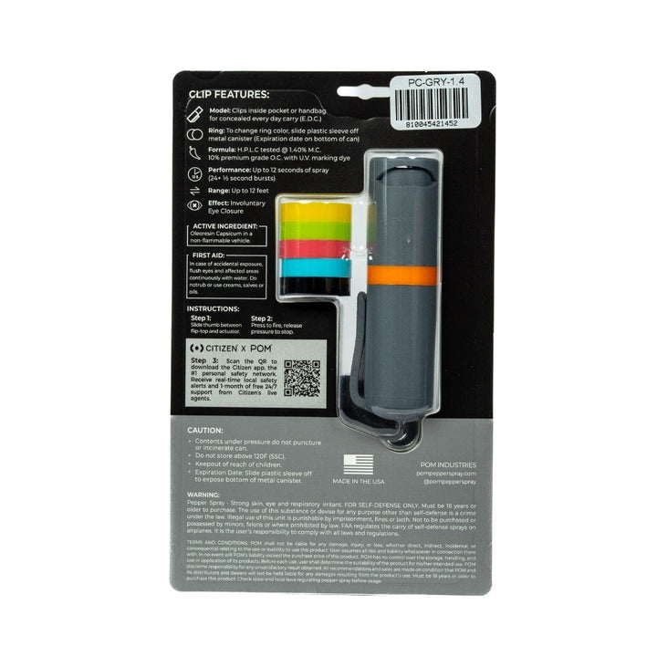 Back view of POM Clip Pepper Spray packaging by POM, featuring product details, usage instructions, caution info, barcode, and manufacturer details. This compact EDC tool has a gray case with an orange stripe and a keychain clip.