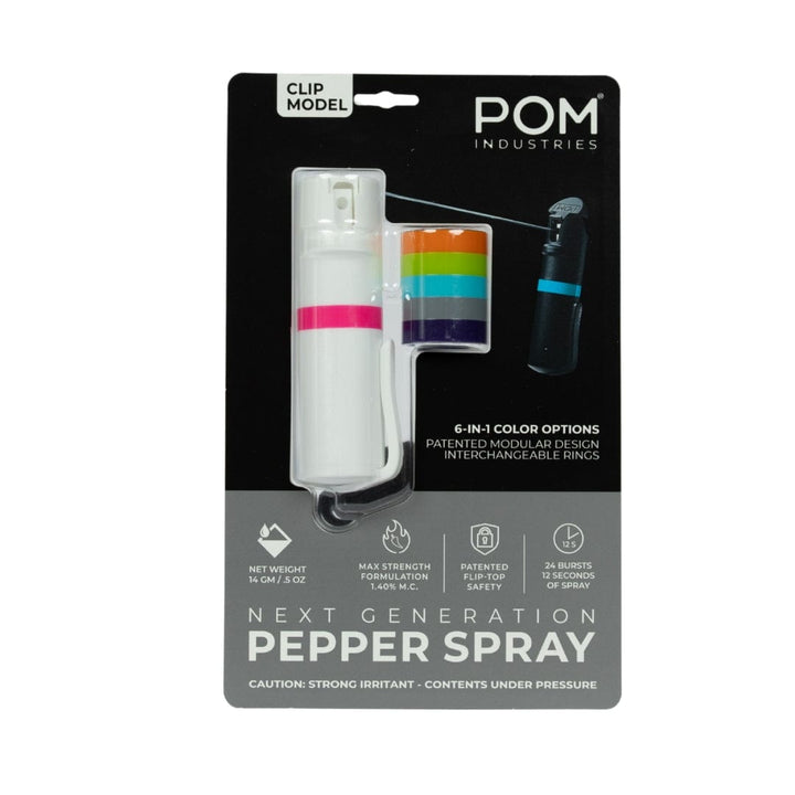The POM Clip Pepper Spray by POM is a next-gen, compact EDC self-defense tool with a white canister, interchangeable colored rings, patented safety, and max strength—packaged to highlight its unique features.