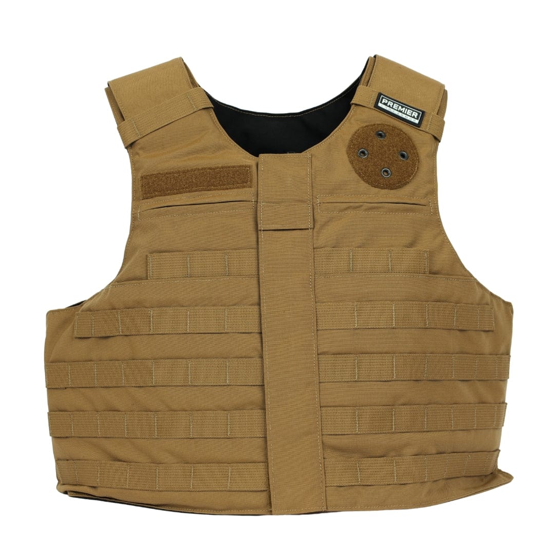 The Patrol Foxtrot by Premier Body Armor is a tan carrier vest featuring multiple horizontal webbing straps, Velcro patches, padded shoulder straps, plate pockets, and a small black "PREMIER" label near the collar.