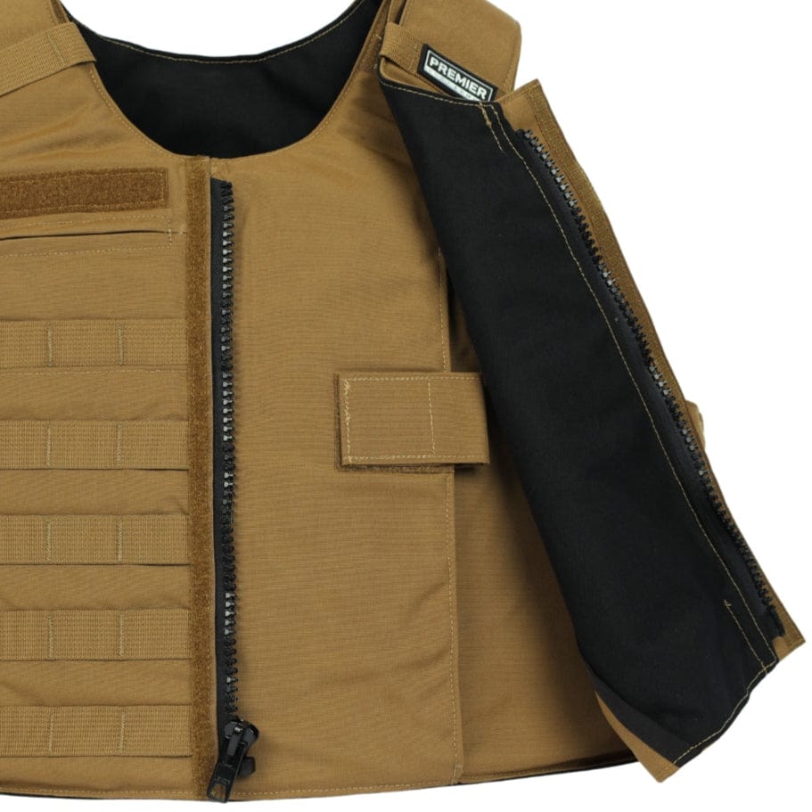 A tan Premier Body Armor Patrol Foxtrot carrier with a partially open front zipper reveals a black interior. The vest has horizontal webbing, plate pockets, Velcro front patch, and a visible "Premier" label inside the collar.