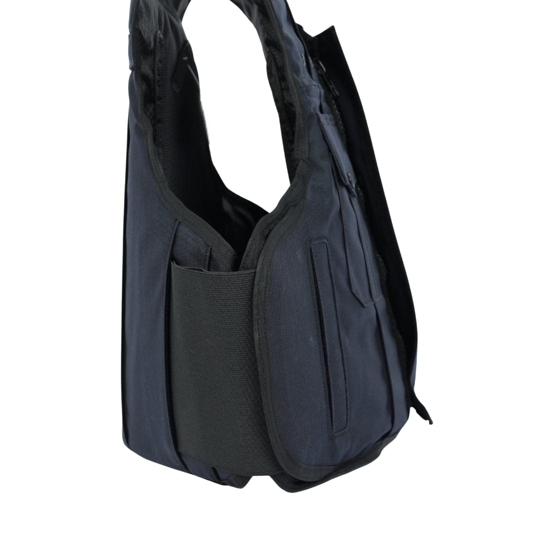 A close-up side view of the Premier Body Armor Patrol India black, padded overt patrol carrier vest with a large pocket and adjustable straps, shown against a plain white background.