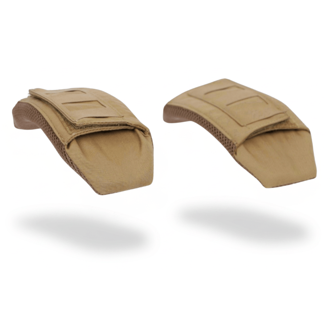 Two tan-colored Fortis Shoulder Pads by Premier Body Armor are shown against a white background with shadows beneath them. Military and first responder discounts may be available for eligible purchasers.