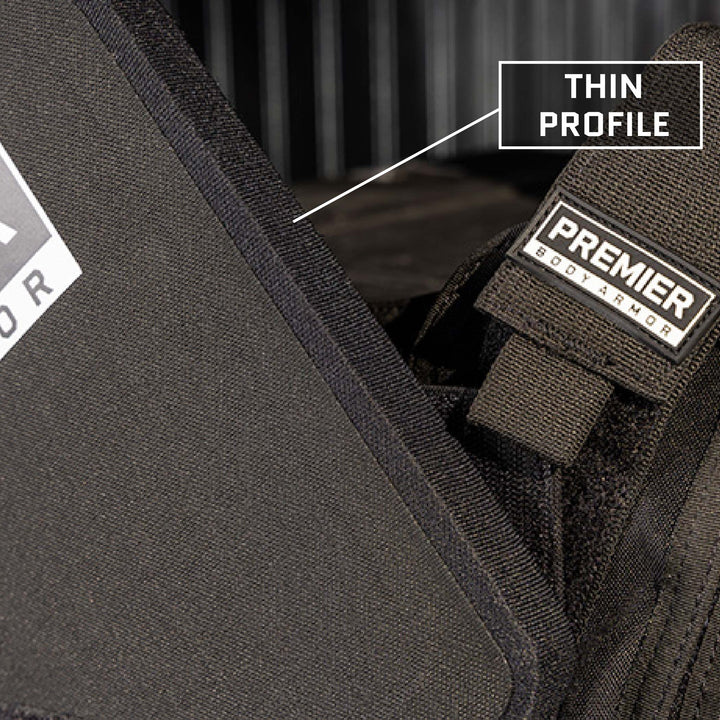 Close-up shot of a black Adaptable Response Loadout with a thin profile. A tag reads "Premier Body Armor". An arrow pointing to the vest is labeled "Thin Profile". The focus is on the texture and design of the vest, showcasing its integration with Level IIIA ballistic panels.