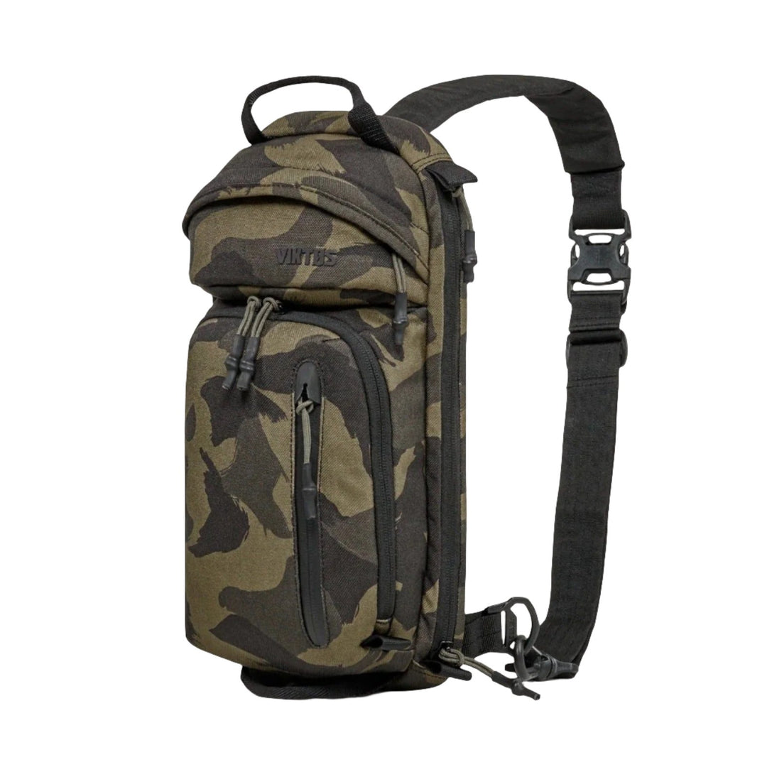 The Viktos Upscale3 Sling is a camouflage-patterned sling backpack with a black adjustable strap. It features several zippered compartments, including a front pocket, main storage area, and side pouch. The brand name "Viktos" is visible on the top front. This upscale sling bag also accommodates concealed carry for added security.