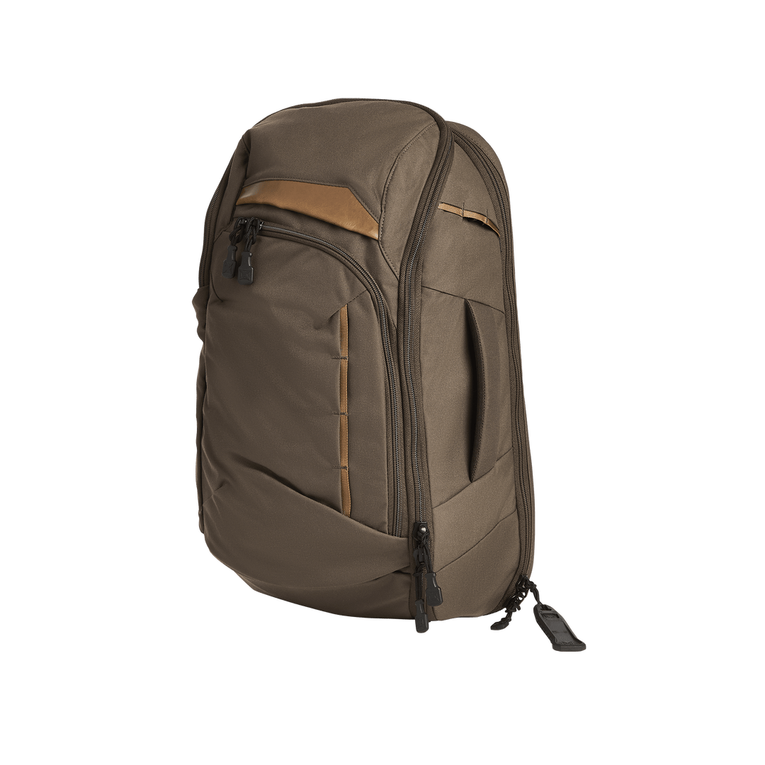 The Vertx Gamut 22L Sling by Vertx is a brown backpack with black zippers, a tan accent, and multiple compartments, including a dedicated CCW compartment, shown standing upright on a plain white background.