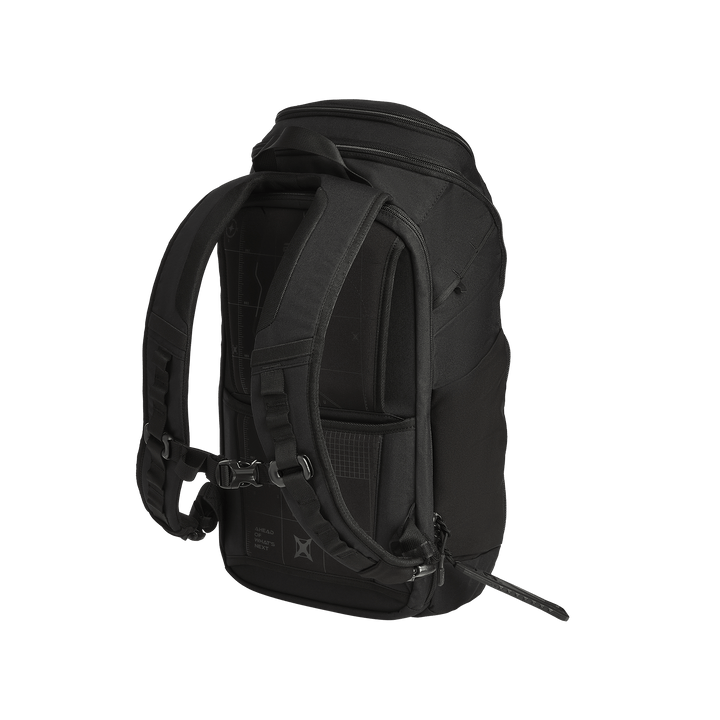 The Vertx Gamut 22L Pack by Vertx is shown from the back, highlighting its padded shoulder straps, ventilated back panel, side pocket, and rapid-access CCW compartment, all set against a plain white background.