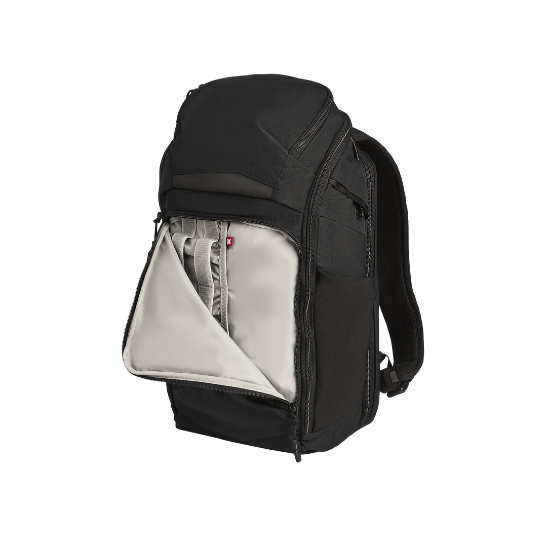 The Vertx Gamut 22L Pack by Vertx is a black EDC backpack shown upright against a white background, with its front compartment unzipped to reveal a light gray interior featuring multiple pockets and organizers for quick access.