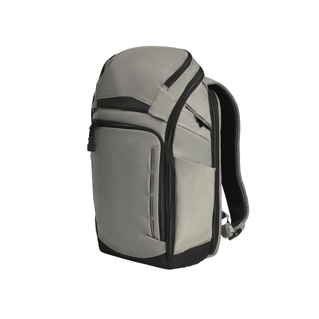 The Vertx Gamut 22L Pack by Vertx in Slate Grey/Black features multiple zippered compartments, rapid access features, and padded shoulder straps in a sleek, modern design, displayed against a plain white background.