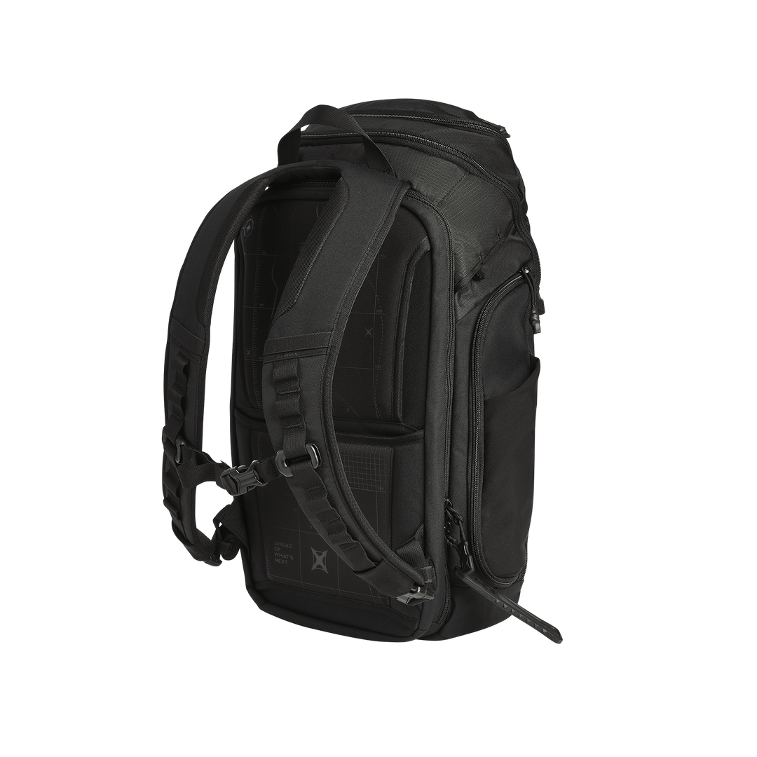 The Vertx Gamut 26L Pack by Vertx is a black EDC backpack with padded shoulder straps, adjustable chest strap, multiple zippered compartments — including a rapid-access CCW compartment — and a sturdy top handle, shown from the back and side.