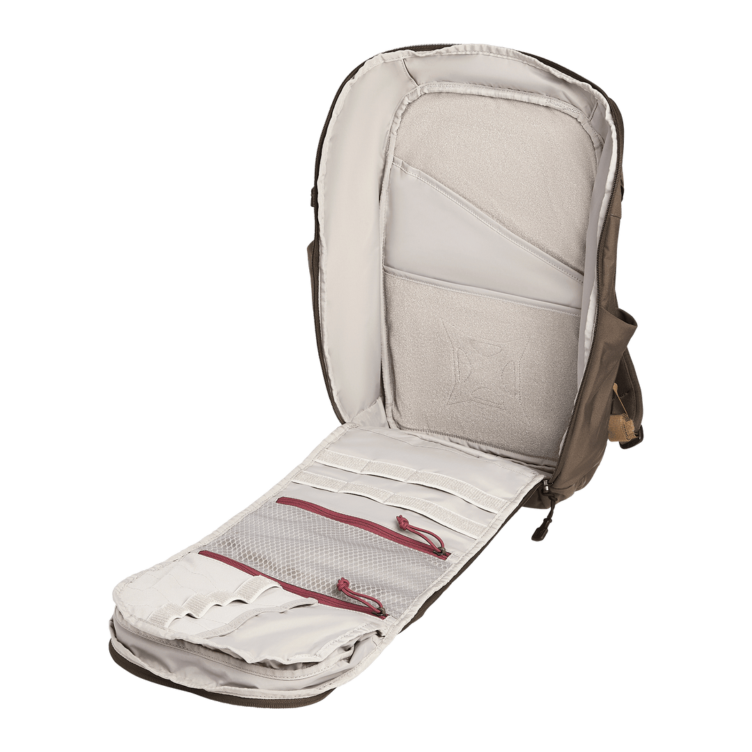 The Vertx Gamut 26L Pack by Vertx is pictured upright on a white background, unzipped to display its beige interior with organized compartments, mesh pockets, elastic loops, and a rapid-access CCW compartment.