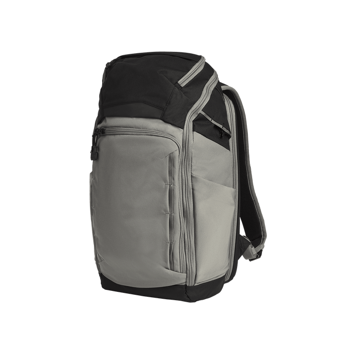 The Vertx Gamut 26L Pack by Vertx is a gray and black EDC backpack with a zippered main compartment, front zip pocket, side pocket, CCW compartment, and padded shoulder straps, shown upright on a plain white background.