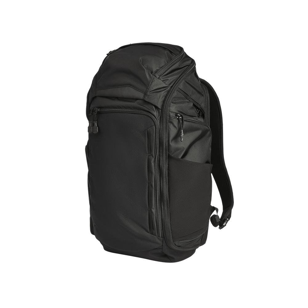 The Vertx Gamut 32L Pack by Vertx is a black travel backpack featuring multiple zippered compartments, side pockets, and padded shoulder straps, pictured standing upright against a plain white background.
