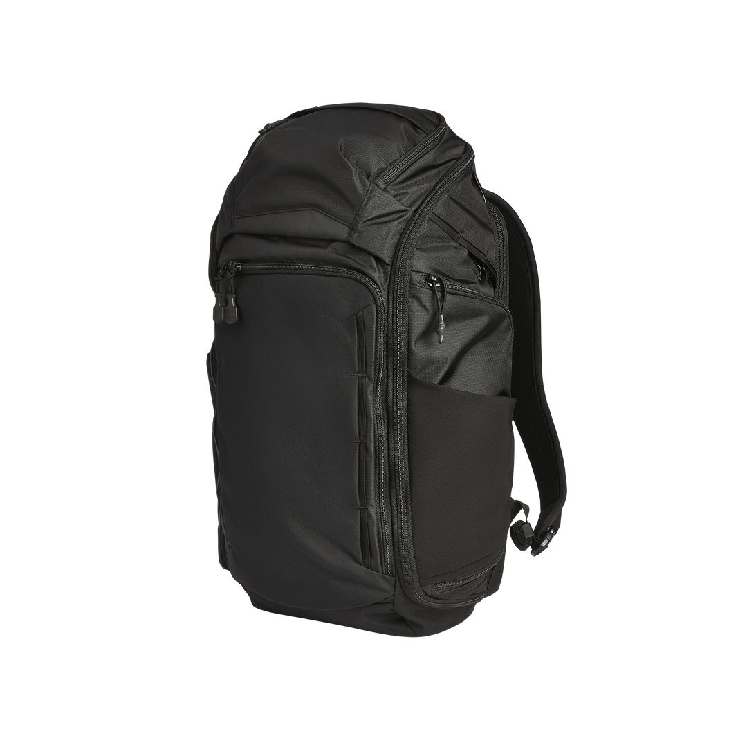 The Vertx Gamut 32L Pack by Vertx is a black travel backpack featuring multiple zippered compartments, side pockets, and padded shoulder straps, pictured standing upright against a plain white background.
