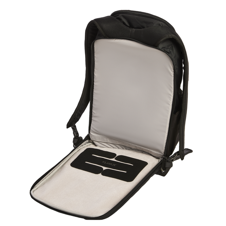 The Vertx Ready Pack X by Vertx is shown open and flat, revealing a padded compartment, a CCW compartment, and a removable black foam insert on its light inner lining.