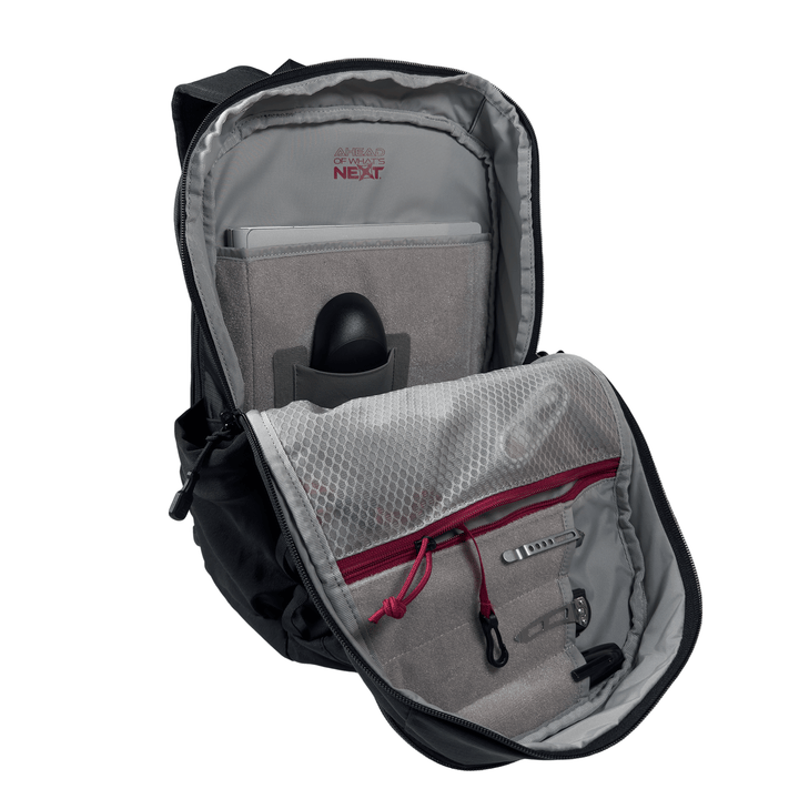 The Vertx Ready Pack X by Vertx is an open black EDC backpack featuring a padded laptop sleeve, mesh zippered pocket, pen holders, organized gray interior with red accents, and a secure dedicated CCW compartment.