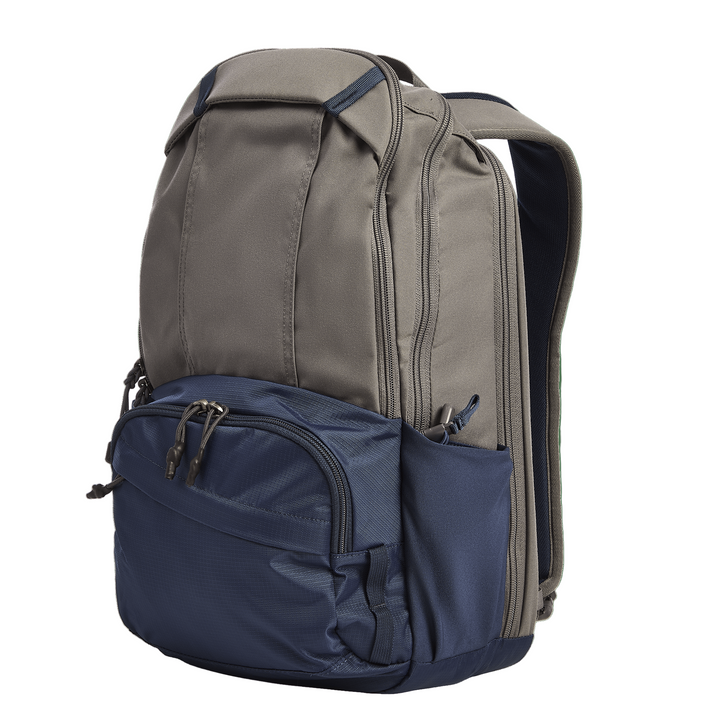A Vertx Ready Pack X backpack in gray and navy is shown upright against a white background, featuring multiple zippered compartments, a dedicated CCW compartment, and adjustable shoulder straps.