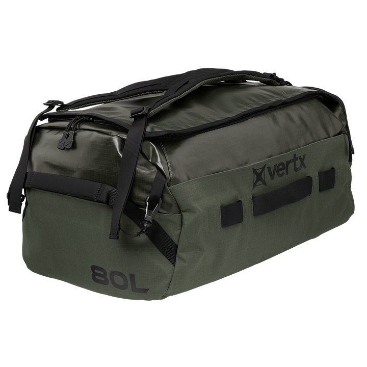 The Vertx RLT Duffel, with its green color complemented by black straps and zippers, boasts a durable design. The side of the bag displays the brand logo along with its 80L capacity, and it offers customizable storage solutions to accommodate various packing requirements.