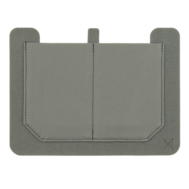 The Vertx Stretch Pocket Large by Vertx is a gray rectangular cardholder featuring two stitched compartments, a small tab at the top, and Vertx loop-lined carry for added convenience. It has slightly rounded corners and a subtle logo in the bottom right corner, crafted from fabric or canvas.