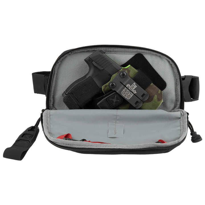 The Vertx Everyday Fanny Pack 2.0 by Vertx is a black zippered pouch with side straps, shown open to display a compact handgun in a holster and fabric items, making it perfect for off-body carry.