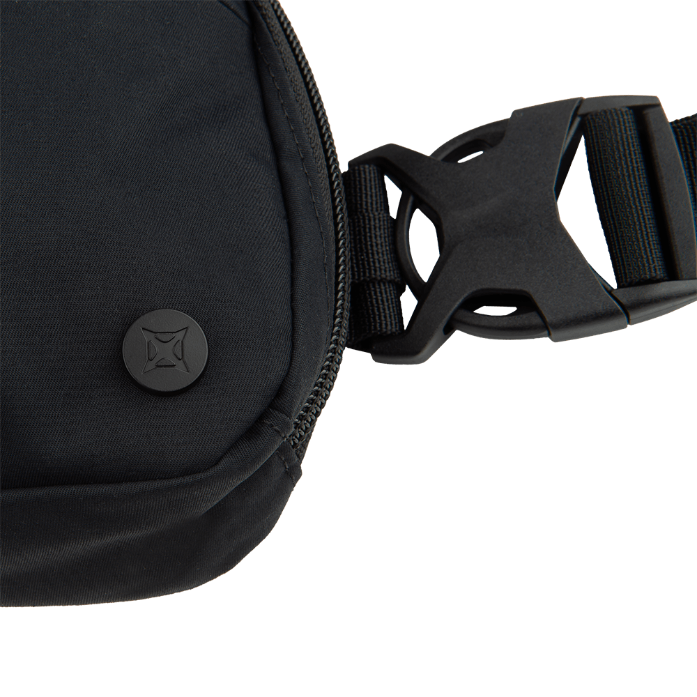 Close-up of the Vertx Everyday Fanny Pack 2.0 in black, featuring a concealed carry design, zipper closure, logo-embossed round button, and an adjustable strap with a large plastic buckle.