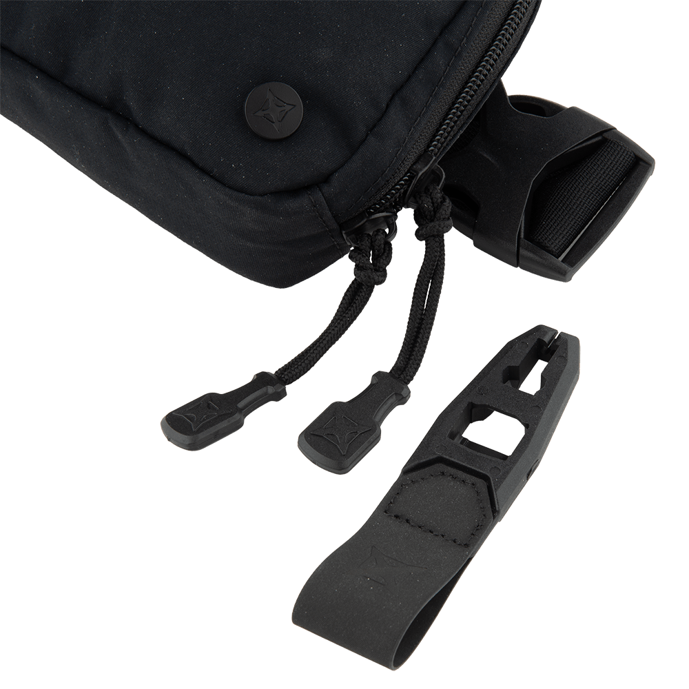 A close-up of the Vertx Everyday Fanny Pack 2.0 by Vertx shows its black zippered design with dual zipper pulls and a detachable black plastic looped attachment with geometric cutouts, all displayed against a white background.