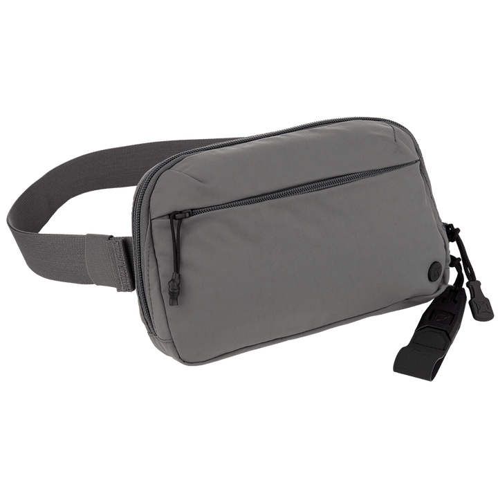 The Vertx Everyday Fanny Pack 2.0 by Vertx is a gray concealed carry fanny pack with a zippered front pocket, adjustable strap, black circular detail, and dual-zippered main compartment for secure off-body carry.