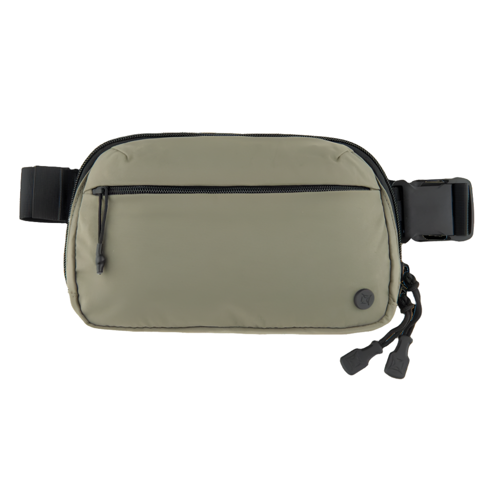 The Vertx Everyday Fanny Pack, a khaki-colored bag designed for daily use, features a black adjustable strap. It includes a front zippered pocket with black zipper pulls, making it ideal for concealed carry. The bottom right corner is adorned with a small circular black logo from the brand Vertx.