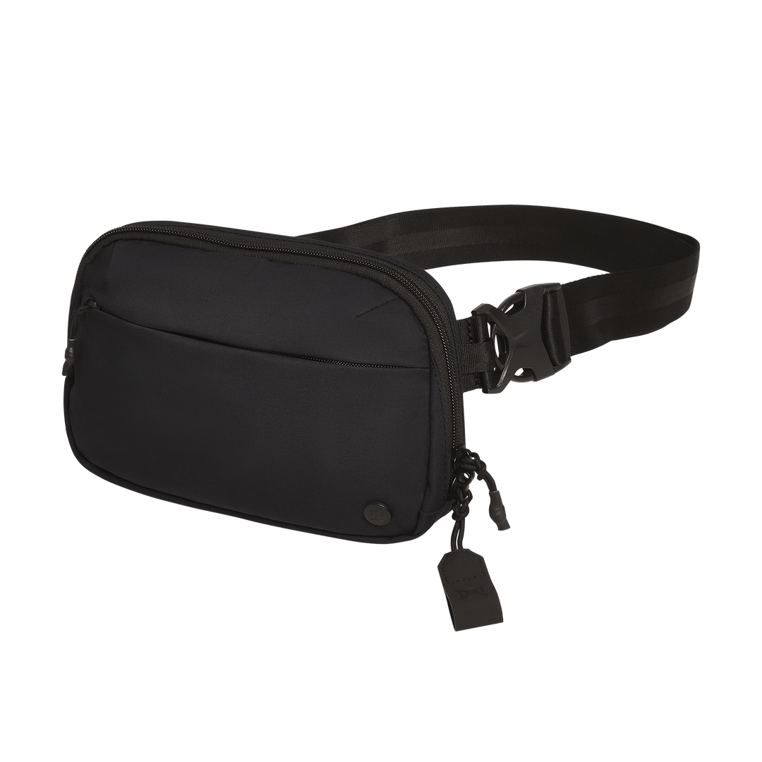 The Vertx Everyday Fanny Pack 2.1 by Vertx is a black EDC waist pack with an adjustable strap and buckle, featuring a front pocket, two zipper pulls with tags, and compatibility with ballistic panels for added security.