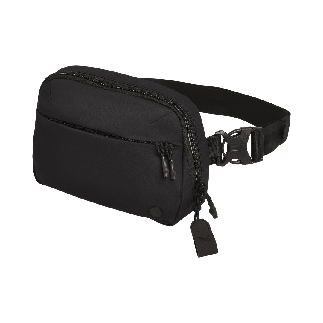 The Vertx Everyday Fanny Pack+ in black features multiple zippered compartments, an adjustable strap with side buckle closure, and a ballistic-panel compatible design. Shown against a white background.