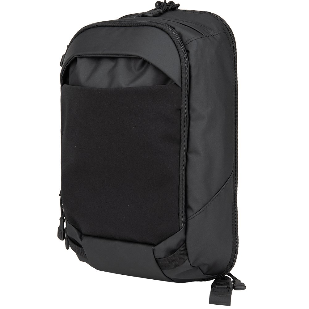 The Vertx Urban Ghost Sling by Vertx is a stylish black backpack with a smooth finish, complemented by a front pocket, zipper closures, and adjustable shoulder straps. Its contemporary, minimalist design includes a concealed carry compartment, making it perfect for various uses.