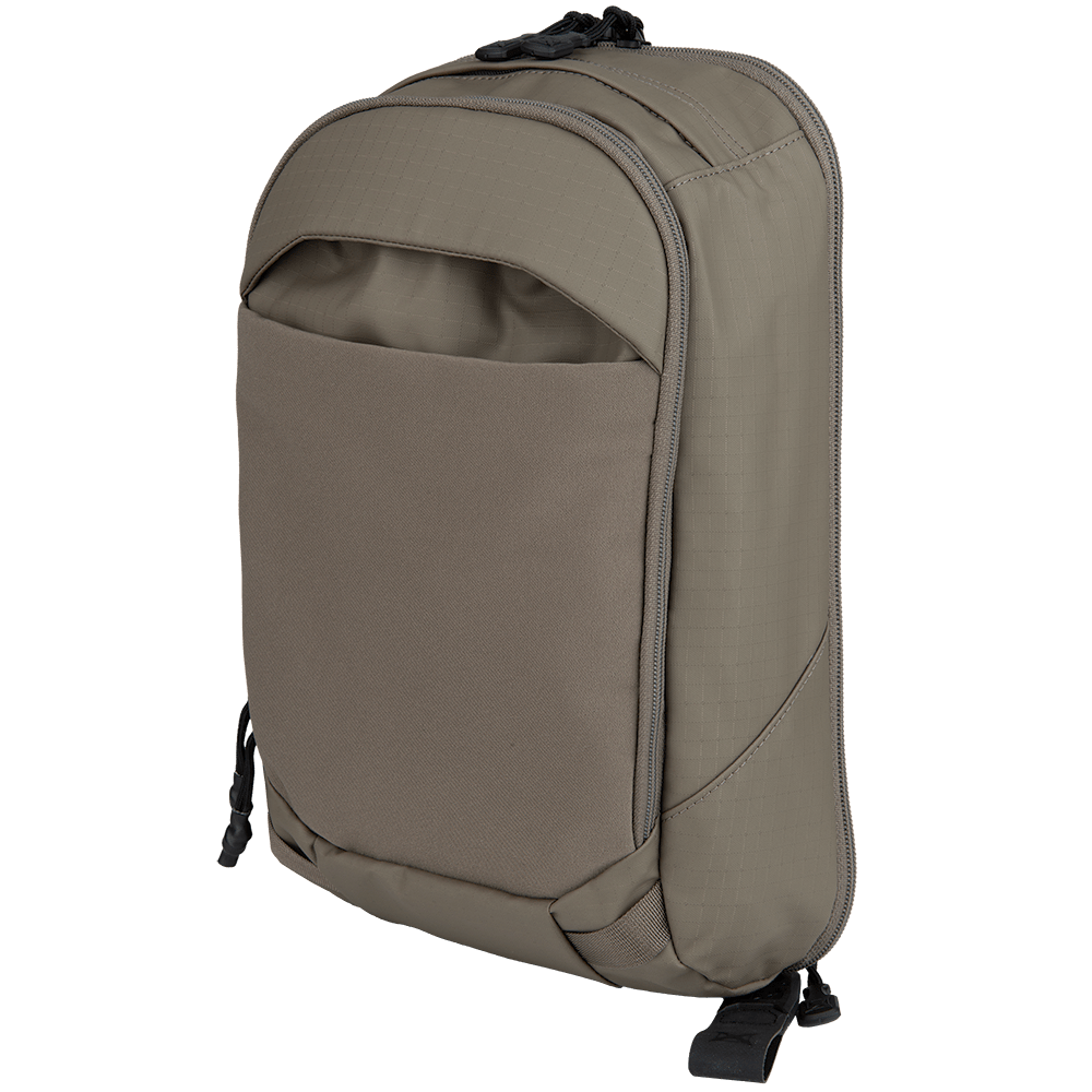 The Vertx Urban Ghost Sling by Vertx is a sleek gray backpack featuring a streamlined design, ideal for everyday carry (EDC) gear. It includes a front pocket, zippered top, padded straps, and a discreet CCW compartment. The fabric is durable and weather-resistant.