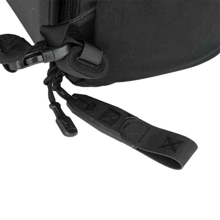 Close-up of a black zipper featuring a black corded pull tab on a Vertx Urban Ghost Pack, crafted from durable ripstop fabric. The zipper is partially open.