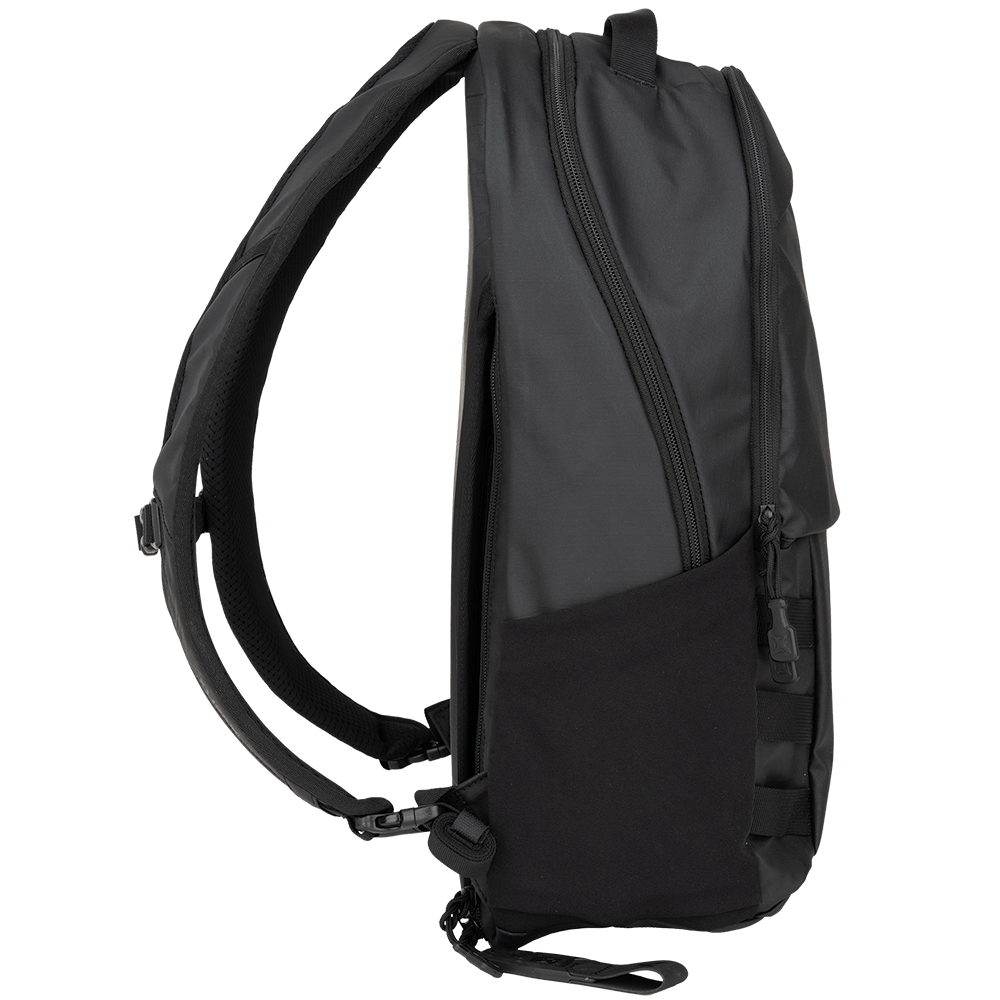 The Vertx Urban Ghost Pack is displayed from the side on a white background. This black backpack boasts a sleek design crafted from durable ripstop fabric, featuring a main compartment, side pocket, and padded shoulder straps. The zippers and stitching are clearly visible.