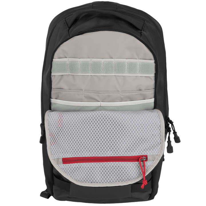 A Vertx Urban Ghost Pack is shown in black and gray, highlighting its organizational compartments. The interior includes vertical straps, a mesh pocket with a red zipper, and additional storage spaces made from durable ripstop fabric.