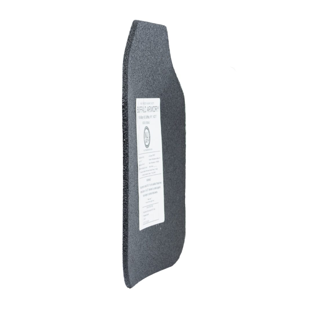 A Buffalo Armory STAR Multi-Curve Level III+ Plate by Premier Body Armor stands upright at an angle with a white information label on its dark gray surface, set against a plain white background to emphasize this ballistic protection item.