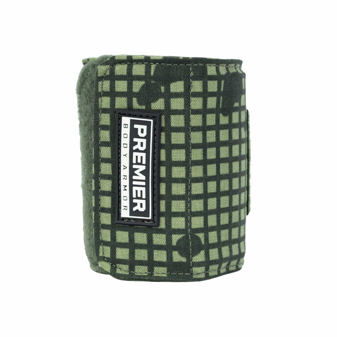 Introducing the Bulletproof Can Cooler - Limited Edition 2026 by Premier Body Armor: a green, grid-patterned pouch in Desert Night Camo with a rectangular "Premier Body Armor" label, shown upright against a white background—perfect for SHOT Show 2026.