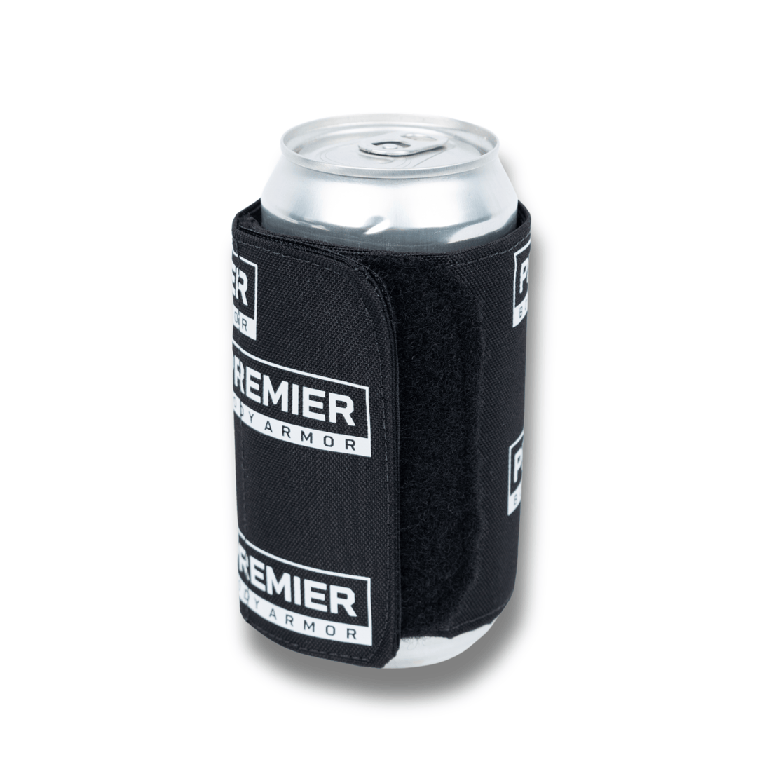 The Bulletproof Can Cooler - Limited Edition by Premier Body Armor features a sleek black design with white logos, stylishly holding a silver can—a unique beer accessory that combines protection and style.