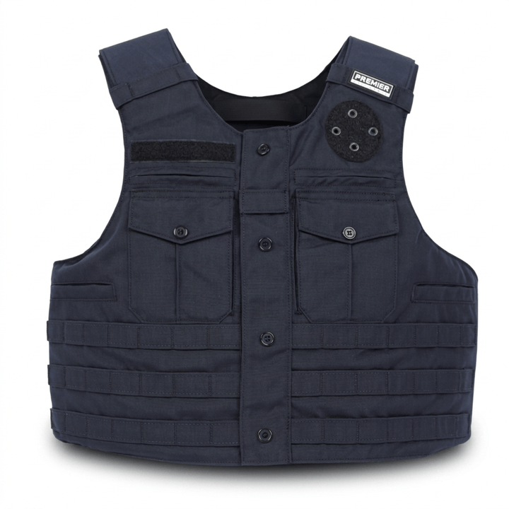 A dark navy tactical vest with front button closure, two chest flap pockets, MOLLE webbing on the lower front, a black velcro patch on the left chest, and a circular black attachment point on the right shoulder.