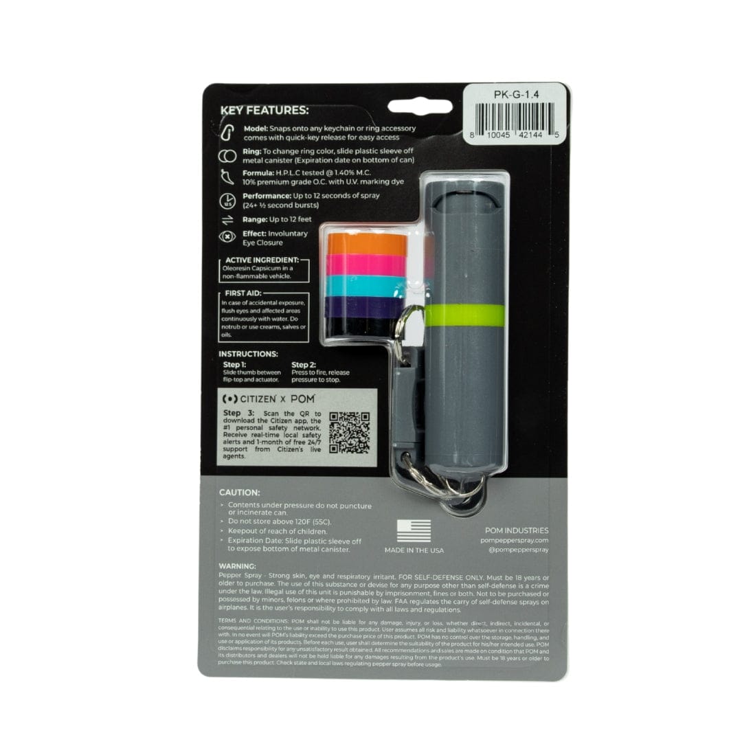 Back of a POM Keychain Pepper Spray package by POM, showing quick-release keychain, color-coded rings, barcode, instructions, key features, caution and warning text in white on a black background.