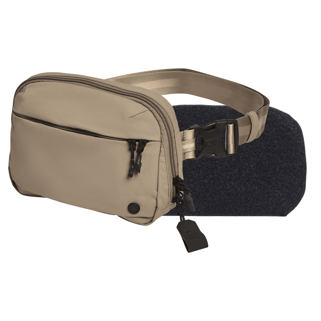 The Vertx/Premier Armored Vertx Everyday Fanny Pack+ Bundle is shown in beige with two zippered compartments, black zipper pulls, and a beige adjustable strap with a black buckle, displayed on a plain white background.