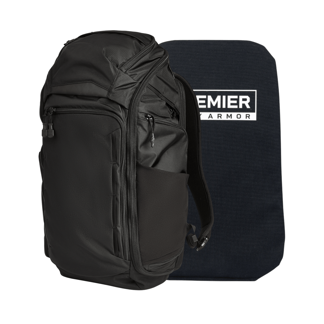 A Vertx/Premier Armored Gamut 32L Pack stands upright beside a rectangular dark blue Premier Armor Level IIIA ballistic panel, which is slightly taller than the backpack.